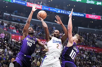 Feb 25, 2024; Los Angeles, California, USA; LA Clippers forward Kawhi Leonard (2) passes the ball against Sacramento Kings forward Harrison Barnes (40) and forward Domantas Sabonis (10) in the first half at Crypto.com Arena. Mandatory Credit: Kirby Lee-USA TODAY Sports