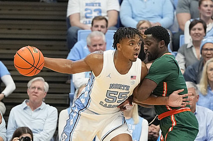 Feb 26, 2024; Chapel Hill, North Carolina, USA; North Carolina Tar Heels forward Harrison Ingram (55) with the ball as Miami (Fl) Hurricanes guard Bensley Joseph (4) defends in the first half at Dean E. Smith Center. Mandatory Credit: Bob Donnan-USA TODAY Sports
