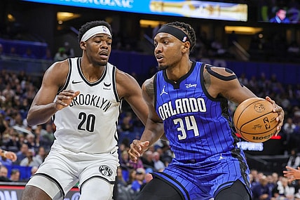 Feb 27, 2024; Orlando, Florida, USA; Orlando Magic center Wendell Carter Jr. (34) drives to the basket against Brooklyn Nets center Day'Ron Sharpe (20) during the first quarter at Amway Center. Mandatory Credit: Mike Watters-USA TODAY Sports