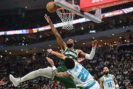 Feb 27, 2024; Milwaukee, Wisconsin, USA;  Milwaukee Bucks guard Malik Beasley (5) takes a shot against Charlotte Hornets guard Tre Mann (23) in the first quarter at Fiserv Forum. Mandatory Credit: Benny Sieu-USA TODAY Sports
