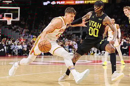 Feb 27, 2024; Atlanta, Georgia, USA; Atlanta Hawks guard Bogdan Bogdanovic (13) drives on Utah Jazz guard Jordan Clarkson (00) in the second quarter at State Farm Arena. Mandatory Credit: Brett Davis-USA TODAY Sports