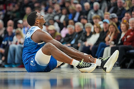 Feb 27, 2024; Minneapolis, Minnesota, USA; Minnesota Timberwolves guard Anthony Edwards (5) holds his ankle on the ground against the San Antonio Spurs in the second quarter at Target Center. Mandatory Credit: Brad Rempel-USA TODAY Sports