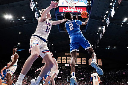 Feb 27, 2024; Lawrence, Kansas, USA; Brigham Young Cougars guard Jaxson Robinson (2) shoots as Kansas Jayhawks guard Johnny Furphy (10) defends during the second half at Allen Fieldhouse. Mandatory Credit: Denny Medley-USA TODAY Sports