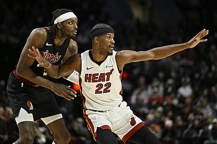 Feb 27, 2024; Portland, Oregon, USA; Miami Heat forward Jimmy Butler (22) reaches for a pass during the second half against Portland Trail Blazers forward Jerami Grant (9) at Moda Center. Mandatory Credit: Troy Wayrynen-USA TODAY Sports