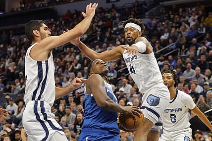 Feb 28, 2024; Minneapolis, Minnesota, USA; Minnesota Timberwolves guard Anthony Edwards (5) goes to the basket between Memphis Grizzlies forward Santi Aldama (7) and guard Jordan Goodwin (4) in the first quarter at Target Center. Mandatory Credit: Bruce Kluckhohn-USA TODAY Sports