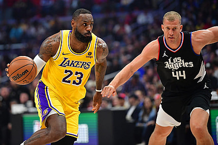 Feb 28, 2024; Los Angeles, California, USA; Los Angeles Lakers forward LeBron James (23) moves the ball against Los Angeles Clippers center Mason Plumlee (44) during the first half at Crypto.com Arena. Mandatory Credit: Gary A. Vasquez-USA TODAY Sports