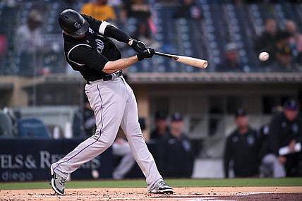 May 18, 2021; San Diego, California, USA; Colorado Rockies first baseman CJ Cron (25) singles against the San Diego Padres during the second inning at Petco Park. Mandatory Credit: Orlando Ramirez-USA TODAY Sports