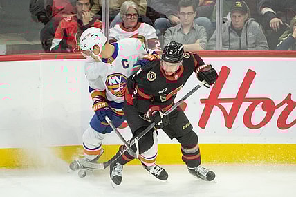 Nov 24 2023; Ottawa, Ontario, CAN; New York Islanders left wing Anders Lee (27) battles with Ottawa Senators defenseman Artem Zub (2) in the third period at the Canadian Tire Centre. Mandatory Credit: Marc DesRosiers-USA TODAY Sports