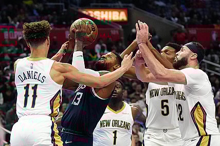 Nov 24, 2023; Los Angeles, California, USA; LA Clippers forward Paul George (13) shoots the ball against New Orleans Pelicans guard Dyson Daniels (11) and forwards Zion Williamson (1), Herbert Jones (5) and Larry Nance Jr. (22) in the second half at Crypto.com Arena. Mandatory Credit: Kirby Lee-USA TODAY Sports