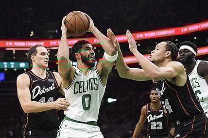 Dec 28, 2023; Boston, Massachusetts, USA;  Boston Celtics forward Jayson Tatum (0) drives to the basket while Detroit Pistons forward Kevin Knox II (24) defends during the first half at TD Garden. Mandatory Credit: Bob DeChiara-USA TODAY Sports