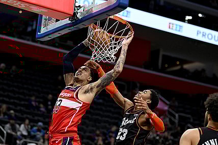 Jan 27, 2024; Detroit, Michigan, USA; Washington Wizards forward Kyle Kuzma (33) dunks the ball over Detroit Pistons guard Jaden Ivey (23) in the fourth quarter at Little Caesars Arena. Mandatory Credit: Lon Horwedel-USA TODAY Sports