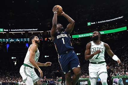 Jan 29, 2024; Boston, Massachusetts, USA;  New Orleans Pelicans forward Zion Williamson (1) shoots the ball between Boston Celtics forward Jayson Tatum (0) and guard Jaylen Brown (7) during the second half at TD Garden. Mandatory Credit: Bob DeChiara-USA TODAY Sports