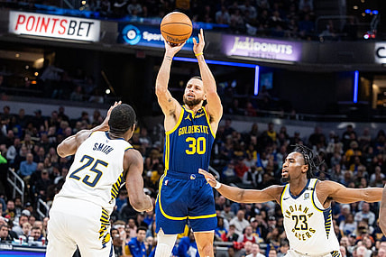 Feb 8, 2024; Indianapolis, Indiana, USA; Golden State Warriors guard Stephen Curry (30) shoots the ball while Indiana Pacers forward Jalen Smith (25) and forward Aaron Nesmith (23)  defend in the first half at Gainbridge Fieldhouse. Mandatory Credit: Trevor Ruszkowski-USA TODAY Sports
