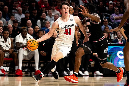 Cincinnati Bearcats guard Simas Lukosius (41) drives on Oklahoma State Cowboys guard Quion Williams (5) in the second half of the NCAA basketball game between Cincinnati Bearcats and Oklahoma State Cowboys at Fifth Third Arena in Cincinnati on Wednesday, Feb. 21, 2024.