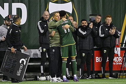 Feb 24, 2024; Portland, Oregon, USA; Portland Timbers head coach Phil Neville hugs forward Antony (11) during the second half against the Colorado Rapids at Providence Park. Mandatory Credit: Troy Wayrynen-USA TODAY Sports