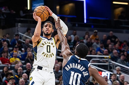 Feb 25, 2024; Indianapolis, Indiana, USA; Indiana Pacers guard Tyrese Haliburton (0) shoots the ball while Dallas Mavericks forward Tim Hardaway Jr. (10) defends in the first half at Gainbridge Fieldhouse. Mandatory Credit: Trevor Ruszkowski-USA TODAY Sports