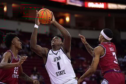 Feb 27, 2024; Fresno, California, USA; Utah State Aggies forward Great Osobor (1) drives to the hoop between Fresno State Bulldogs guard Leo Colimerio (23) and guard Isaiah Hill (3) in the first half at the Save Mart Center. Mandatory Credit: Cary Edmondson-USA TODAY Sports
