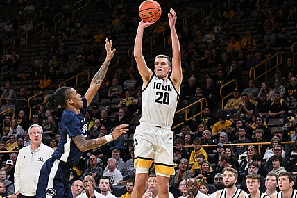 Feb 27, 2024; Iowa City, Iowa, USA; Iowa Hawkeyes forward Payton Sandfort (20) shoots a three point basket over Penn State Nittany Lions guard Nick Kern Jr. (3) as head coach Fran McCaffery looks on during the second half at Carver-Hawkeye Arena. Mandatory Credit: Jeffrey Becker-USA TODAY Sports