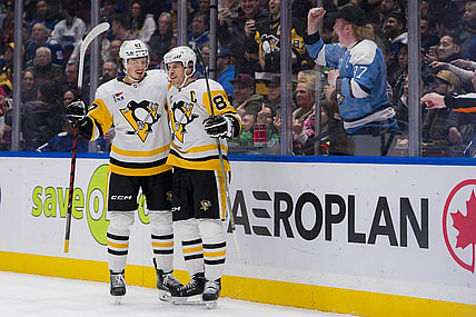 Feb 27, 2024; Vancouver, British Columbia, CAN; Pittsburgh Penguins forward Rickard Rakell (67) and forward Sidney Crosby (87) celebrate Rakell   s second goal of the game against the Vancouver Canucks in the second period at Rogers Arena. Mandatory Credit: Bob Frid-USA TODAY Sports