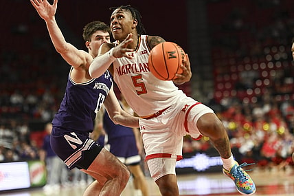 Feb 28, 2024; College Park, Maryland, USA;  Maryland Terrapins guard DeShawn Harris-Smith (5) shoots on Northwestern Wildcats guard Brooks Barnhizer (13) during the second half at Xfinity Center. Mandatory Credit: Tommy Gilligan-USA TODAY Sports