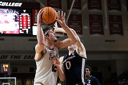 Feb 28, 2024; Chestnut Hill, Massachusetts, USA; Boston College Eagles forward Quinten Post (12) shoots the ball  against Virginia Cavaliers forward Blake Buchanan (0) during the second half at Conte Forum. Mandatory Credit: Eric Canha-USA TODAY Sports