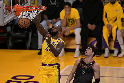 Feb 29, 2024; Los Angeles, California, USA;  Los Angeles Lakers forward LeBron James (23) moves past Washington Wizards forward Deni Avdija (8) for a dunk in the first half at Crypto.com Arena. Mandatory Credit: Jayne Kamin-Oncea-USA TODAY Sports