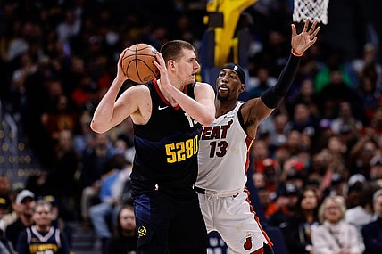 Feb 29, 2024; Denver, Colorado, USA; Denver Nuggets center Nikola Jokic (15) controls the ball as Miami Heat center Bam Adebayo (13) guards in the fourth quarter at Ball Arena. Mandatory Credit: Isaiah J. Downing-USA TODAY Sports