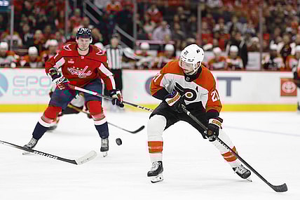 Mar 1, 2024; Washington, District of Columbia, USA; Philadelphia Flyers center Scott Laughton (21) skates with the puck as Washington Capitals center Aliaksei Protas (21) chases in the second period at Capital One Arena. Mandatory Credit: Geoff Burke-USA TODAY Sports