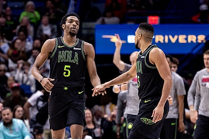 Mar 1, 2024; New Orleans, Louisiana, USA;  New Orleans Pelicans forward Herbert Jones (5) slaps hands with guard CJ McCollum (3) after a play against the Indiana Pacers during the first half at Smoothie King Center. Mandatory Credit: Stephen Lew-USA TODAY Sports