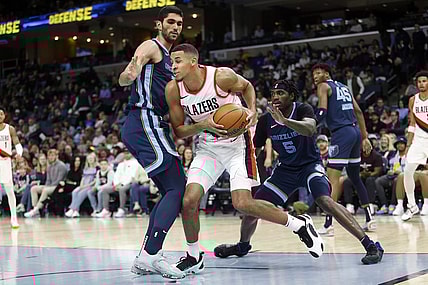 Mar 1, 2024; Memphis, Tennessee, USA; Portland Trail Blazers forward Kris Murray (8) drives to the basket as Memphis Grizzlies forward-center Santi Aldama (7) and Memphis Grizzlies guard Vince Williams Jr. (5) defend during the first half at FedExForum. Mandatory Credit: Petre Thomas-USA TODAY Sports