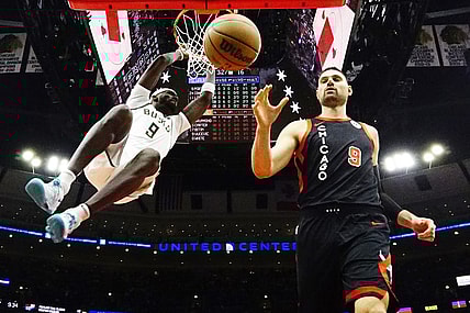 Mar 1, 2024; Chicago, Illinois, USA; Milwaukee Bucks forward Bobby Portis (9) dunks the ball as Chicago Bulls center Nikola Vucevic (9) stands nearby during the first quarter at United Center. Mandatory Credit: David Banks-USA TODAY Sports