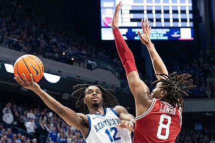 Kentucky Wildcats guard Antonio Reeves (12) goes for a layup against Arkansas Razorbacks forward Chandler Lawson (8) during their game on Saturday, March 2, 2024 at Rupp Arena.