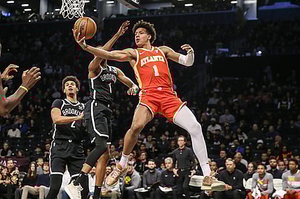 Mar 2, 2024; Brooklyn, New York, USA; Atlanta Hawks forward Jalen Johnson (1) drives past Brooklyn Nets forward Mikal Bridges (1) in the first quarter at Barclays Center. Mandatory Credit: Wendell Cruz-USA TODAY Sports