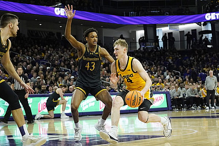 Mar 2, 2024; Evanston, Illinois, USA; Northwestern Wildcats guard Blake Smith (43) defends Iowa Hawkeyes guard Josh Dix (4) during the first half at Welsh-Ryan Arena. Mandatory Credit: David Banks-USA TODAY Sports
