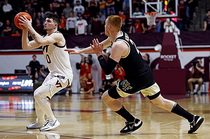 Mar 2, 2024; Blacksburg, Virginia, USA; Virginia Tech Hokies guard Hunter Cattoor (0) shoots the ball against Wake Forest Demon Deacons guard Cameron Hildreth (2) during the second half at Cassell Coliseum. Mandatory Credit: Peter Casey-USA TODAY Sports