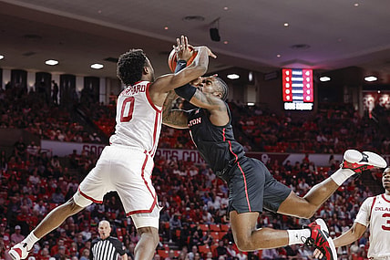 Mar 2, 2024; Norman, Oklahoma, USA; Houston Cougars guard Jamal Shead (1) and Oklahoma Sooners guard Le'Tre Darthard (0) reach for a loose ball during the first half at Lloyd Noble Center. Mandatory Credit: Alonzo Adams-USA TODAY Sports