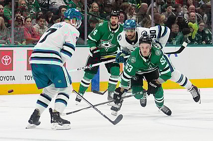 Mar 2, 2024; Dallas, Texas, USA;  Dallas Stars center Wyatt Johnston (53) and San Jose Sharks right wing Justin Bailey (90) chase the puck during the second period at American Airlines Center. Mandatory Credit: Chris Jones-USA TODAY Sports