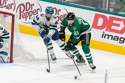 Mar 2, 2024; Dallas, Texas, USA;  Dallas Stars left wing Jason Robertson (21) skates with the puck as San Jose Sharks defenseman Marc-Edouard Vlasic (44) defends during the third period at American Airlines Center. Mandatory Credit: Chris Jones-USA TODAY Sports