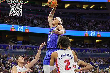 Mar 3, 2024; Orlando, Florida, USA; Orlando Magic forward Paolo Banchero (5) dunks against Detroit Pistons forward Simone Fontecchio (19) during the second quarter at KIA Center. Mandatory Credit: Mike Watters-USA TODAY Sports