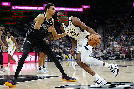 Mar 3, 2024; San Antonio, Texas, USA; Indiana Pacers forward Jalen Smith (25) dribbles against San Antonio Spurs center Victor Wembanyama (1) in the first half at Frost Bank Center. Mandatory Credit: Daniel Dunn-USA TODAY Sports