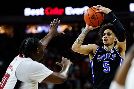 Mar 4, 2024; Raleigh, North Carolina, USA; Duke Blue Devils guard Jeremy Roach (3) shoots the ball past North Carolina State Wolfpack forward DJ Burns Jr. (30) during the first half at PNC Arena. Mandatory Credit: Jaylynn Nash-USA TODAY Sports
