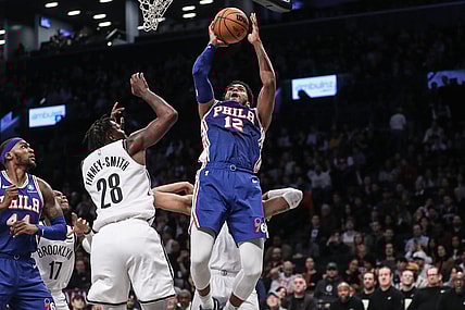 Mar 5, 2024; Brooklyn, New York, USA; Philadelphia 76ers forward Tobias Harris (12) drives past Brooklyn Nets forward Dorian Finney-Smith (28) for a jump shot in the second quarter at Barclays Center. Mandatory Credit: Wendell Cruz-USA TODAY Sports