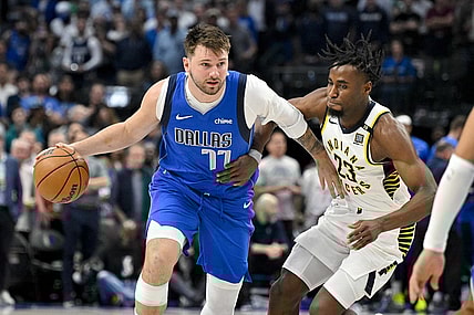 Mar 5, 2024; Dallas, Texas, USA; Dallas Mavericks guard Luka Doncic (77) looks to move the ball past Indiana Pacers forward Aaron Nesmith (23) during the first quarter at the American Airlines Center. Mandatory Credit: Jerome Miron-USA TODAY Sports