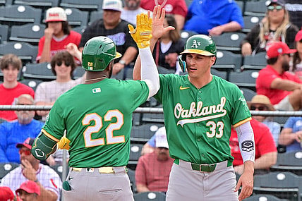Mar 6, 2024; Tempe, Arizona, USA;  Oakland Athletics right fielder Miguel Andujar (22) celebrates with left fielder JJ Bleday (33) after hitting a three run home run in the first inning against the Los Angeles Angels during a spring training game at Tempe Diablo Stadium. Mandatory Credit: Matt Kartozian-USA TODAY Sports
