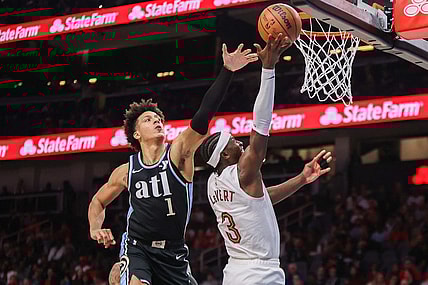 Mar 6, 2024; Atlanta, Georgia, USA; Cleveland Cavaliers guard Caris LeVert (3) shoots past Atlanta Hawks forward Jalen Johnson (1) in the second quarter at State Farm Arena. Mandatory Credit: Brett Davis-USA TODAY Sports