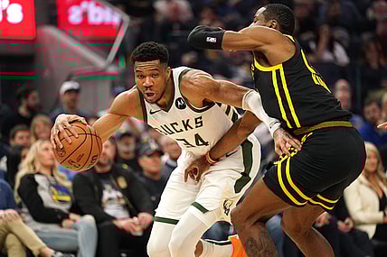 Mar 6, 2024; San Francisco, California, USA; Milwaukee Bucks forward Giannis Antetokounmpo (34) dribbles the ball next to Golden State Warriors forward Jonathan Kuminga (00) in the second quarter at the Chase Center. Mandatory Credit: Cary Edmondson-USA TODAY Sports