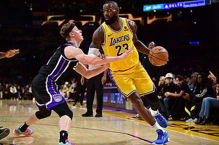 Mar 6, 2024; Los Angeles, California, USA;  Los Angeles Lakers forward LeBron James (23) moves the ball against Sacramento Kings guard Kevin Huerter (9) during the second half at Crypto.com Arena. Mandatory Credit: Gary A. Vasquez-USA TODAY Sports