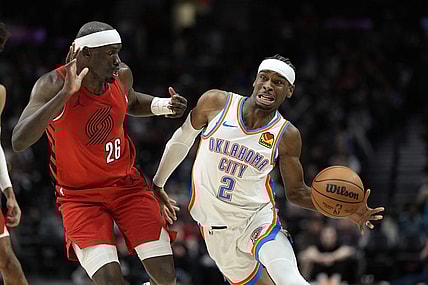 Mar 6, 2024; Portland, Oregon, USA; Oklahoma City Thunder point guard Shai Gilgeous-Alexander (2) is fouled by Portland Trail Blazers center Duop Reath (26) during the second half at Moda Center. Mandatory Credit: Soobum Im-USA TODAY Sports