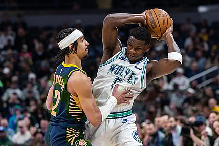 Mar 7, 2024; Indianapolis, Indiana, USA; Minnesota Timberwolves guard Anthony Edwards (5) holds the ball while Indiana Pacers guard Andrew Nembhard (2) defends during the first half at Gainbridge Fieldhouse. Mandatory Credit: Trevor Ruszkowski-USA TODAY Sports