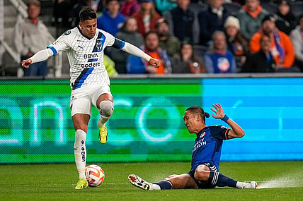 FC Cincinnati forward Yuya Kubo (7) slides under Monterrey midfielder Maximiliano Meza (11) in the first half of the CONCACAF Champions Cup Round of 16 game between the FC Cincinnati and the Monterrey at TQL Stadium in Cincinnati on Thursday, March 7, 2024. Monterrey led 1-0 at halftime.